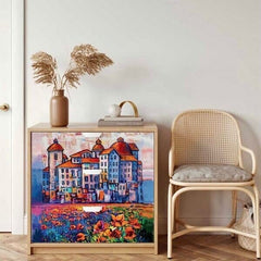 Decoupaged chest of drawers depicting a vivid blue and orange slightly abstract painted scene, scores of poppies in front of what looks like a town in Tuscany.