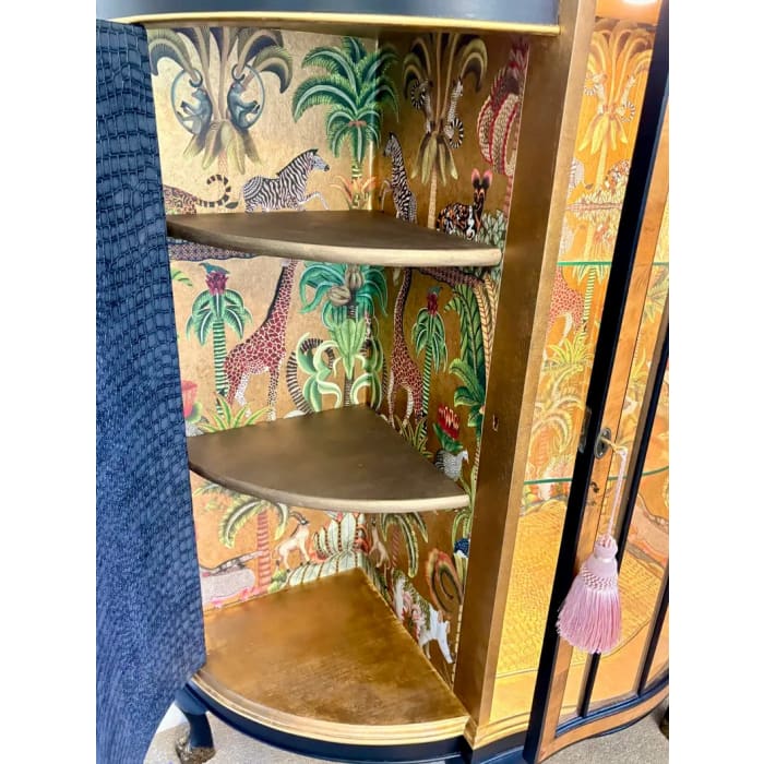 African-inspired interior inside antique burr walnut cabinet
