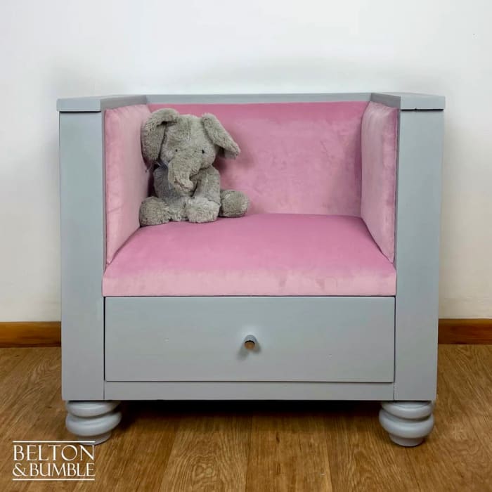 Chair detail of grey reading seat reupholstered in soft pink velvet