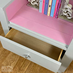 Interior of storage drawers on chair and bookcase for children’s books and toys