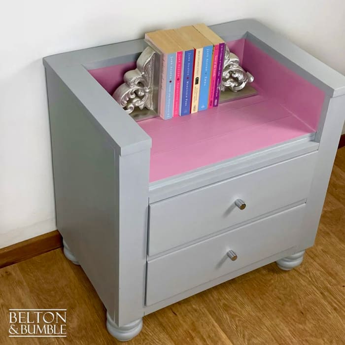 Top of storage drawers on chair and bookcase for children’s books and toys