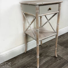 Angled view showing lime-waxed faux bamboo detailing and elegant silhouette