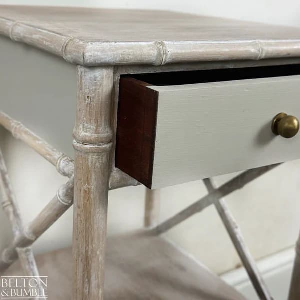 Leg and cross-stretcher detail on lime-waxed faux bamboo bedside table
