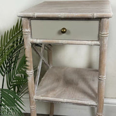 Drawer detail of faux bamboo bedside table with aged brass knob