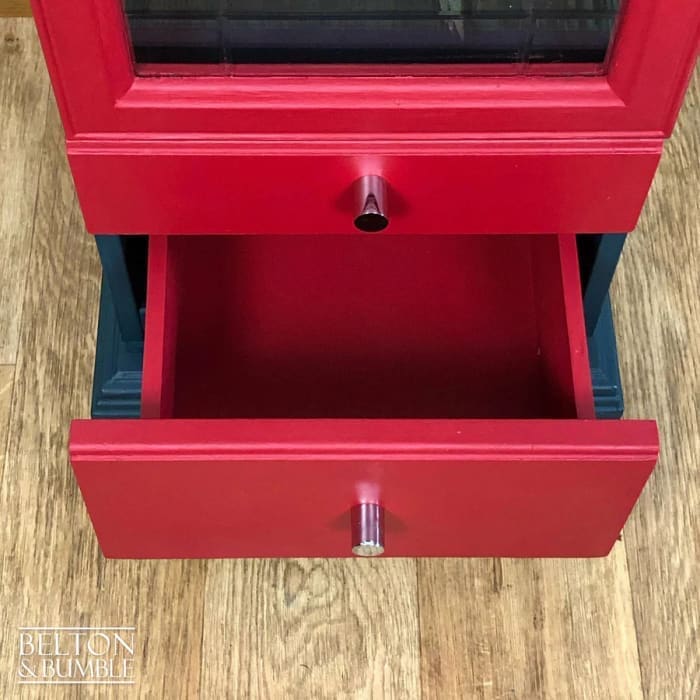 Interior of vintage glass door drinks cabinet showing adjustable shelf for versatile storage