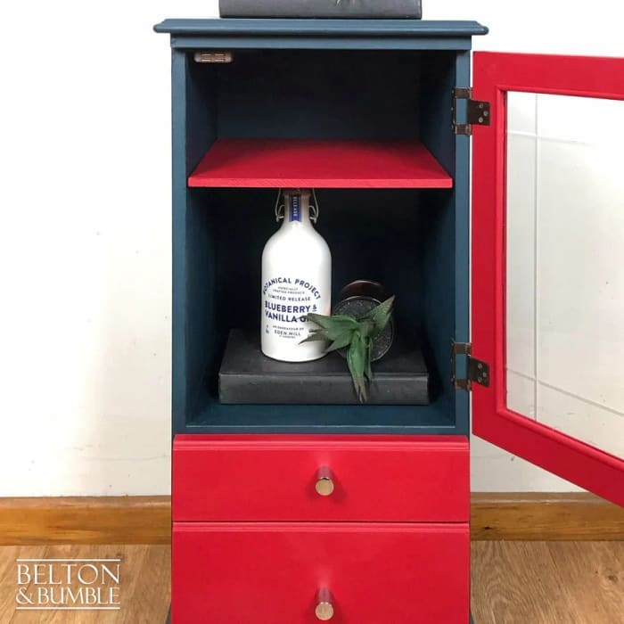 Interior of vintage glass door drinks cabinet showing adjustable shelf for versatile storage