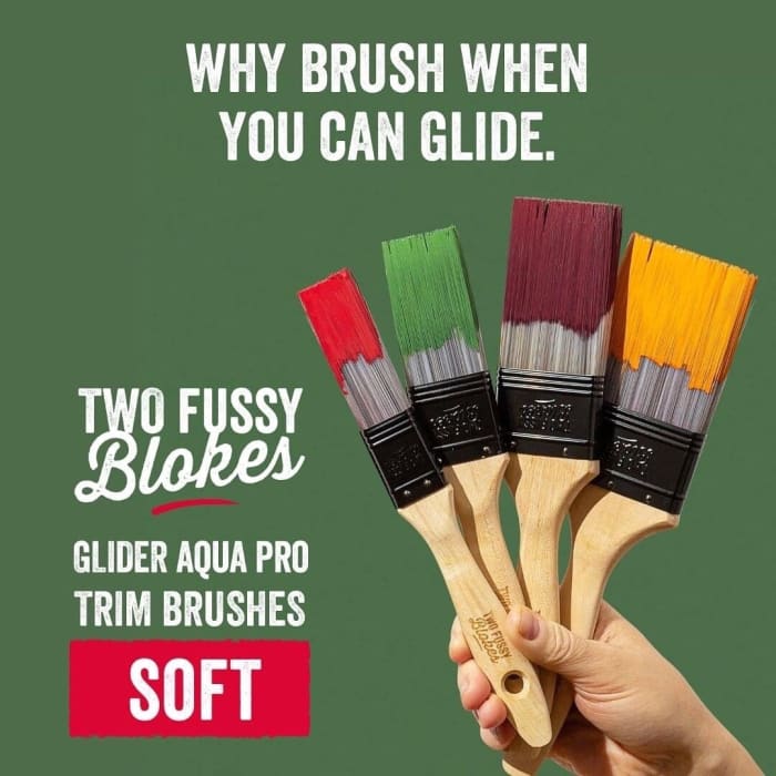 Hand holding four differently sized Glider Aqua Pro Paint Brushes by Two Fussy Blokes, made using soft synthetic filaments designed for water-based paint.