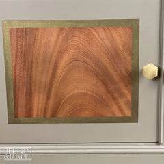 Close-up of bronze detailing on mahogany cocktail cabinet door