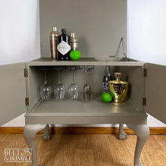 Lift lid detail showing hidden bronze-painted shelf for cocktail serving