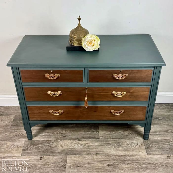 Angled view of restored green chest of drawers with mahogany and walnut detail