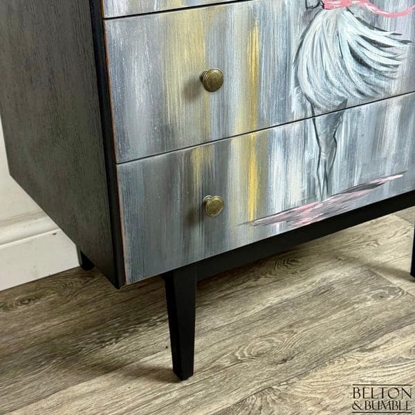 Close-up of black painted legs on jet black hand-painted mid-century chest of drawers