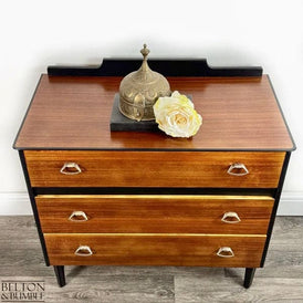 Close-up of teak finish on mid-century modern chest of drawers with teak surfaces