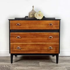 Front view of mid-century modern chest of drawers in jet black with teak fronts by Belton & Bumble