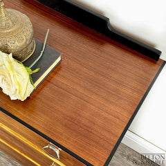 Top view of mid-century modern chest of drawers in jet black with teak fronts by Belton & Bumble