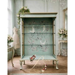 Silver Wings Decor Transfer by Redesign with Prima used on glass cabinet with crane and branch design visible behind shelves