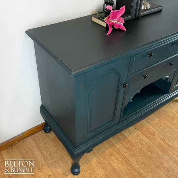 Side profile of solid wood teal sideboard with Queen Anne legs and storage cupboards