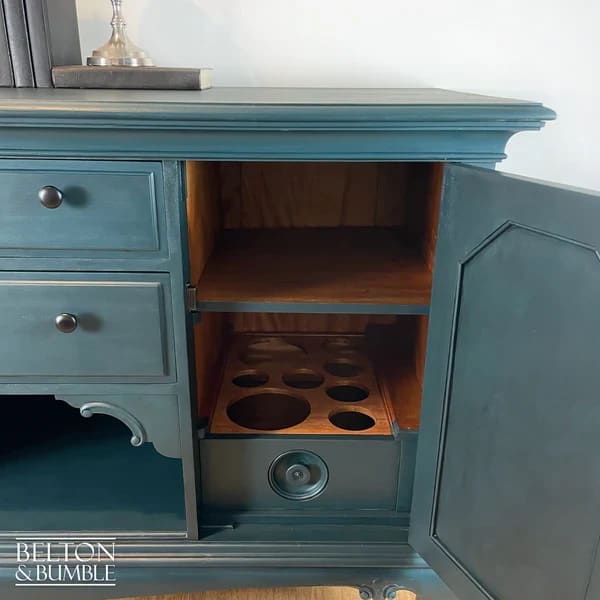 Interior of sideboard right-hand cupboard showing removable shelves and bottle storage cellarette