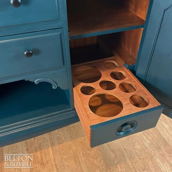 Interior of sideboard showing removable shelves and bottle storage cellarette