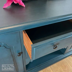 Close-up of dovetail drawers on hand-painted teal sideboard