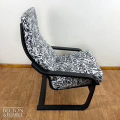 Side view of restored vintage tiger print rocking chair, black frame with monochrome upholstery by Belton & Bumble