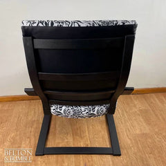 Back of vintage rocking chair with black leatherette and tiger print accent by Belton & Bumble, UK