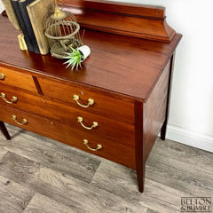 Angled view of vintage mahogany storage chest in natural wood finish