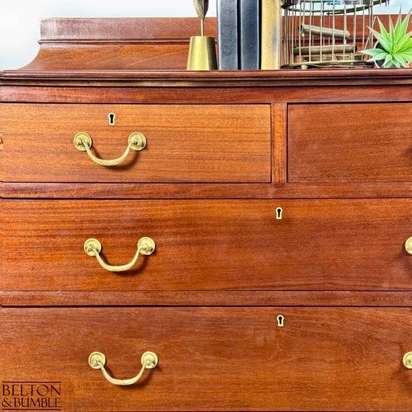 Detail of brass handles on vintage mahogany chest of drawers