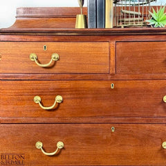 Detail of brass handles on vintage mahogany chest of drawers